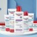 Winter beauty and skin care essentials featuring Eucerin, NIVEA, and Aquaphor products arranged on a clean seasonal background