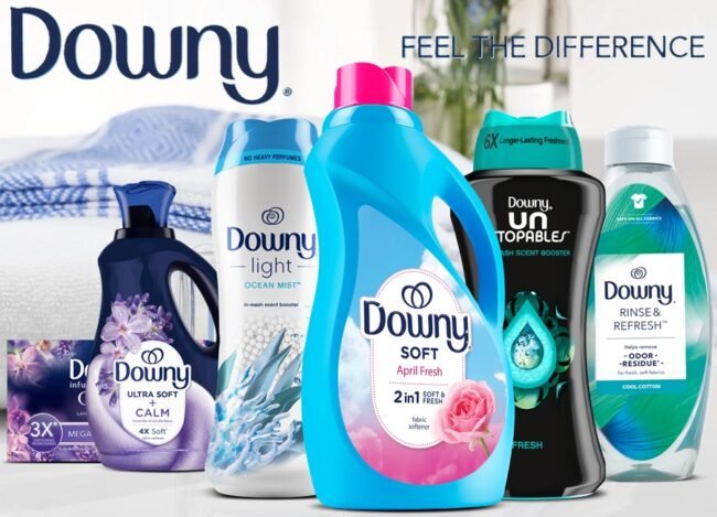 Promotional graphic featuring assorted Downy laundry care products including scent booster beads, dryer sheets, and fabric care items.