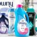 Promotional graphic featuring assorted Downy laundry care products including scent booster beads, dryer sheets, and fabric care items.