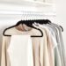 Amazon Basics Slim Velvet Black Hangers neatly stacked on a white counter