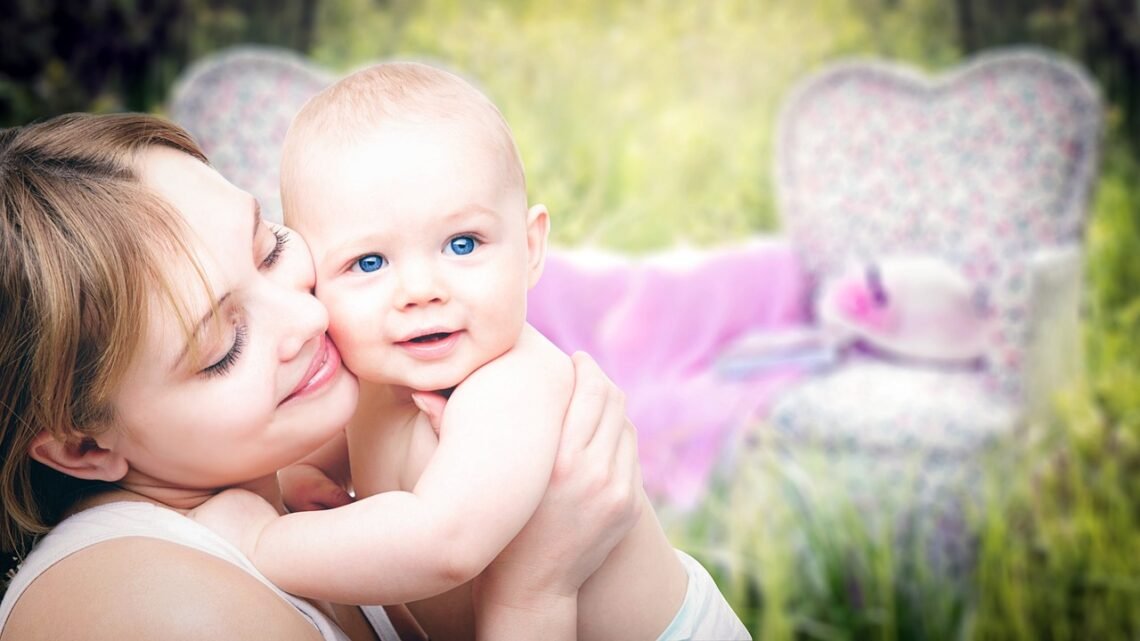 Mother holding baby in a bright room representing baby essentials and everyday infant care products.