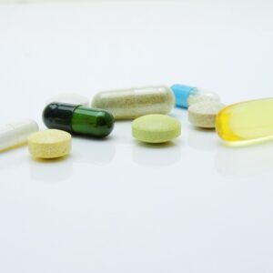 Various dietary supplement bottles and capsules displayed neatly on a tabletop.