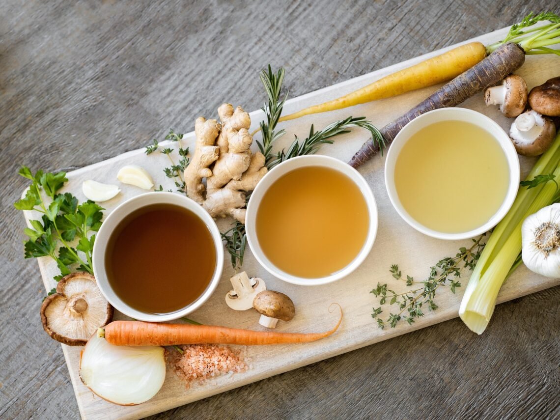 Soup ingredients and broth with vegetables representing cooking with Campbell’s soup and Swanson broth.