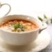 Hearty vegetable soup and minestrone soup in bowls representing chunky soup meal options.