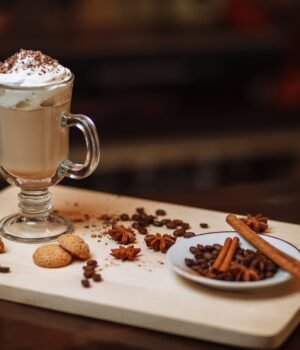 A cozy lifestyle image featuring cookies, coffee, and a relaxed snack setting with warm tones