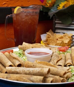 A close-up of tacos and ingredients on a plate with a soft blue sky-inspired background, light cloud textures, and delicate cherry blossom accents creating an airy spring food aesthetic.
