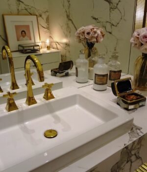 A clean spring-themed bathroom and household setup featuring paper products with soft blue skies, light clouds, and subtle cherry blossom accents for a fresh seasonal feel