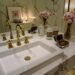 A clean spring-themed bathroom and household setup featuring paper products with soft blue skies, light clouds, and subtle cherry blossom accents for a fresh seasonal feel