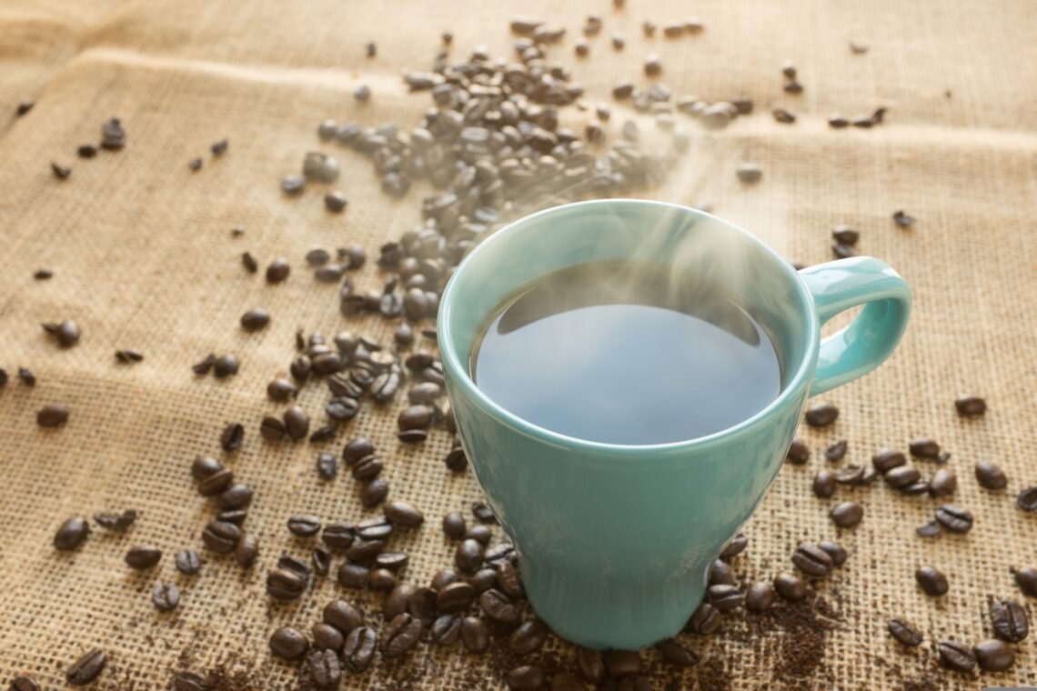 Fresh Roasted Coffee products displayed beside coffee mugs and roasted coffee beans during a featured coffee savings promotion.