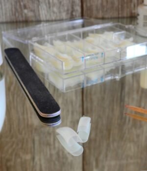 Beauty products including press-on nails and false lashes for at-home styling and self care