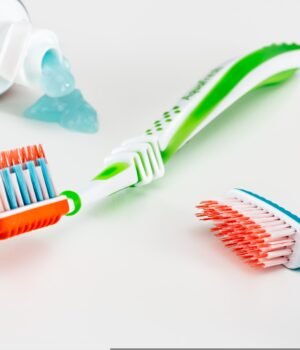 A bright and clean dental care scene with toothbrushes and toothpaste, styled with a soft spring aesthetic and fresh, minimal tones
