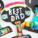 Father's Day gift products including electronics, grilling accessories, apparel, books, and gadgets featured in a promotional sale graphic.