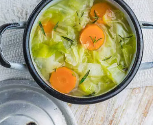 Homemade cabbage and sausage stew with fresh vegetables.