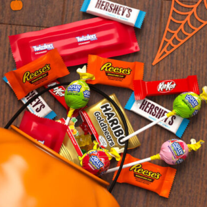 Assorted Hershey Halloween candy bulk packs featuring chocolate, fruity candy, Reese's, Kit Kat, and other individually wrapped treats.