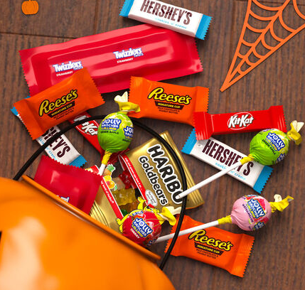 Assorted Hershey Halloween candy bulk packs featuring chocolate, fruity candy, Reese's, Kit Kat, and other individually wrapped treats.