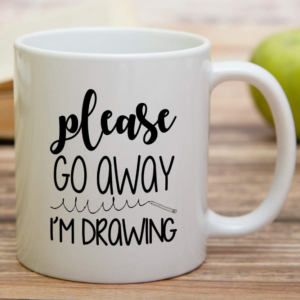 Funny white ceramic mug featuring the phrase “Please Go Away I’m Drawing” for artists and creative people.