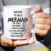 Reasons to Be Mermaid 11-ounce white ceramic coffee mug with a whimsical mermaid-themed design.