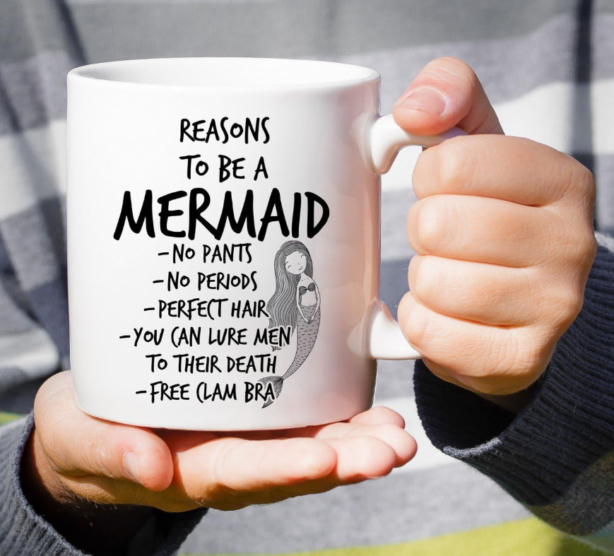 Reasons to Be Mermaid 11-ounce white ceramic coffee mug with a whimsical mermaid-themed design.