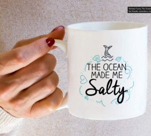 The Ocean Made Me Salty mermaid-themed 11-ounce white ceramic coffee mug.